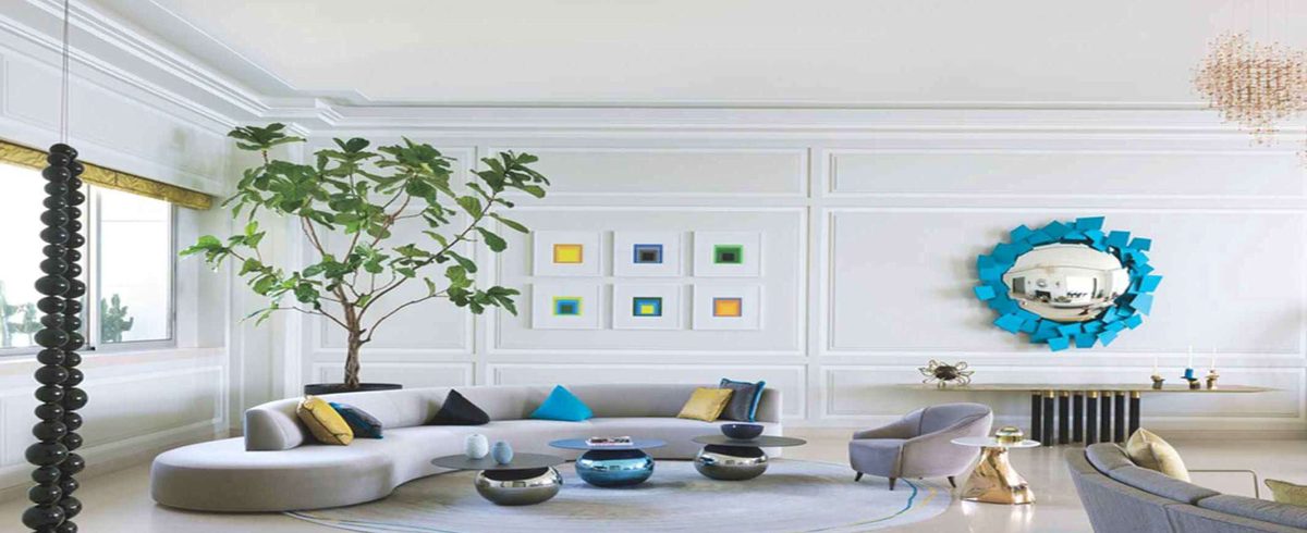 Apartment living room with curved sofa and light stone floor
