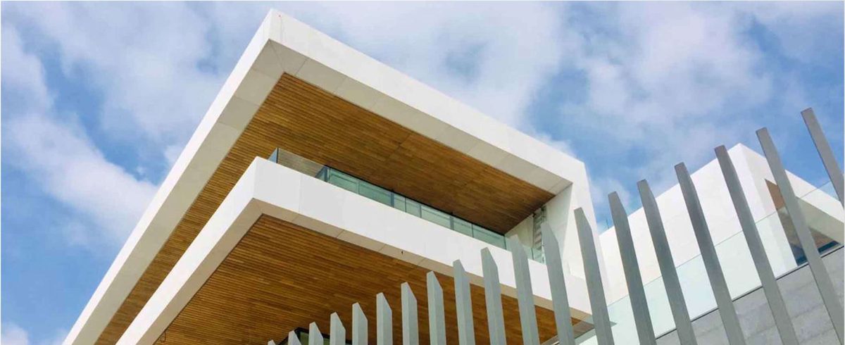 Villa exterior with white cantilevered slabs, timber soffits and vertical metal screens
